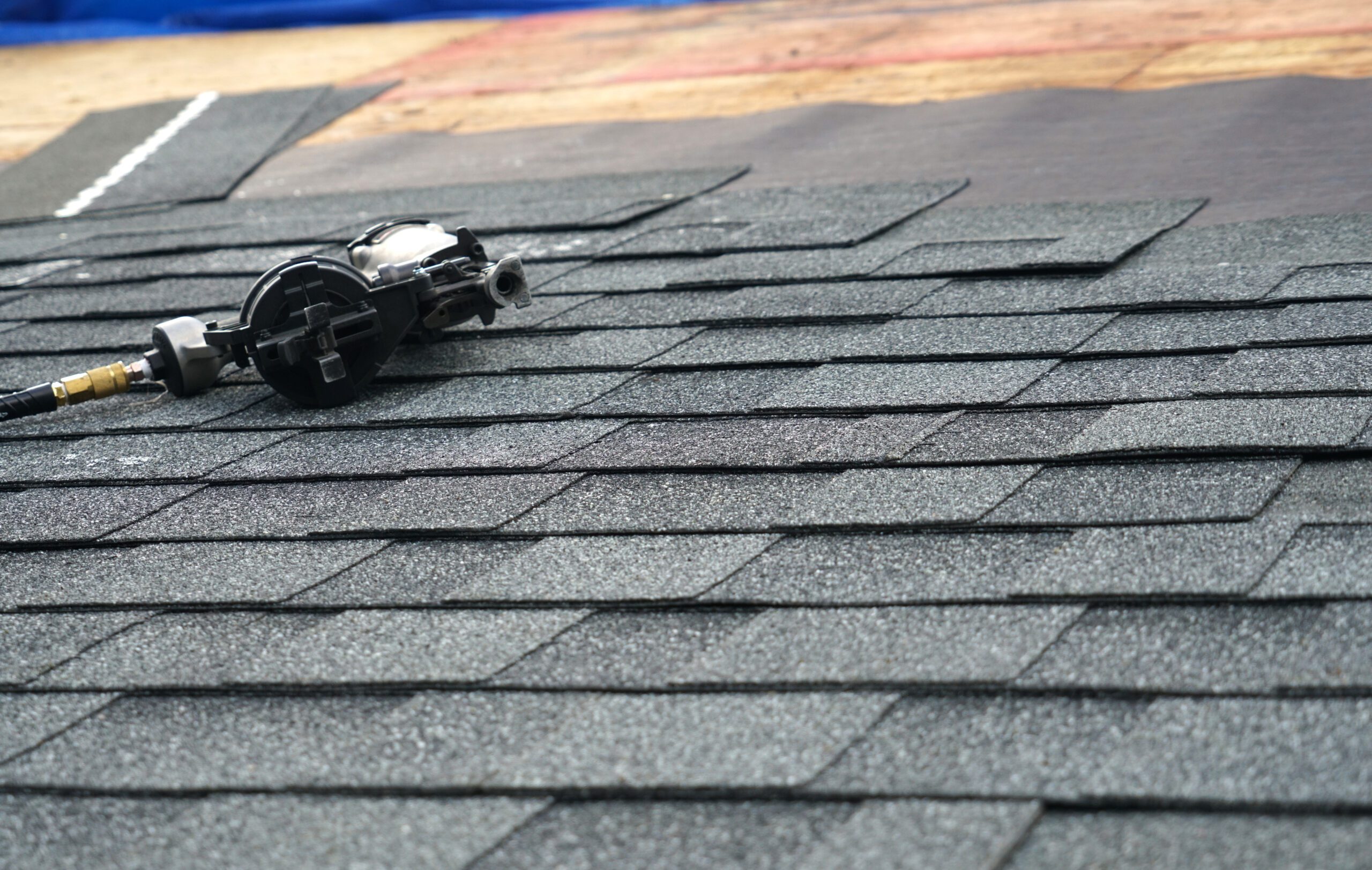 Images of shingles and a nail gun for roofing