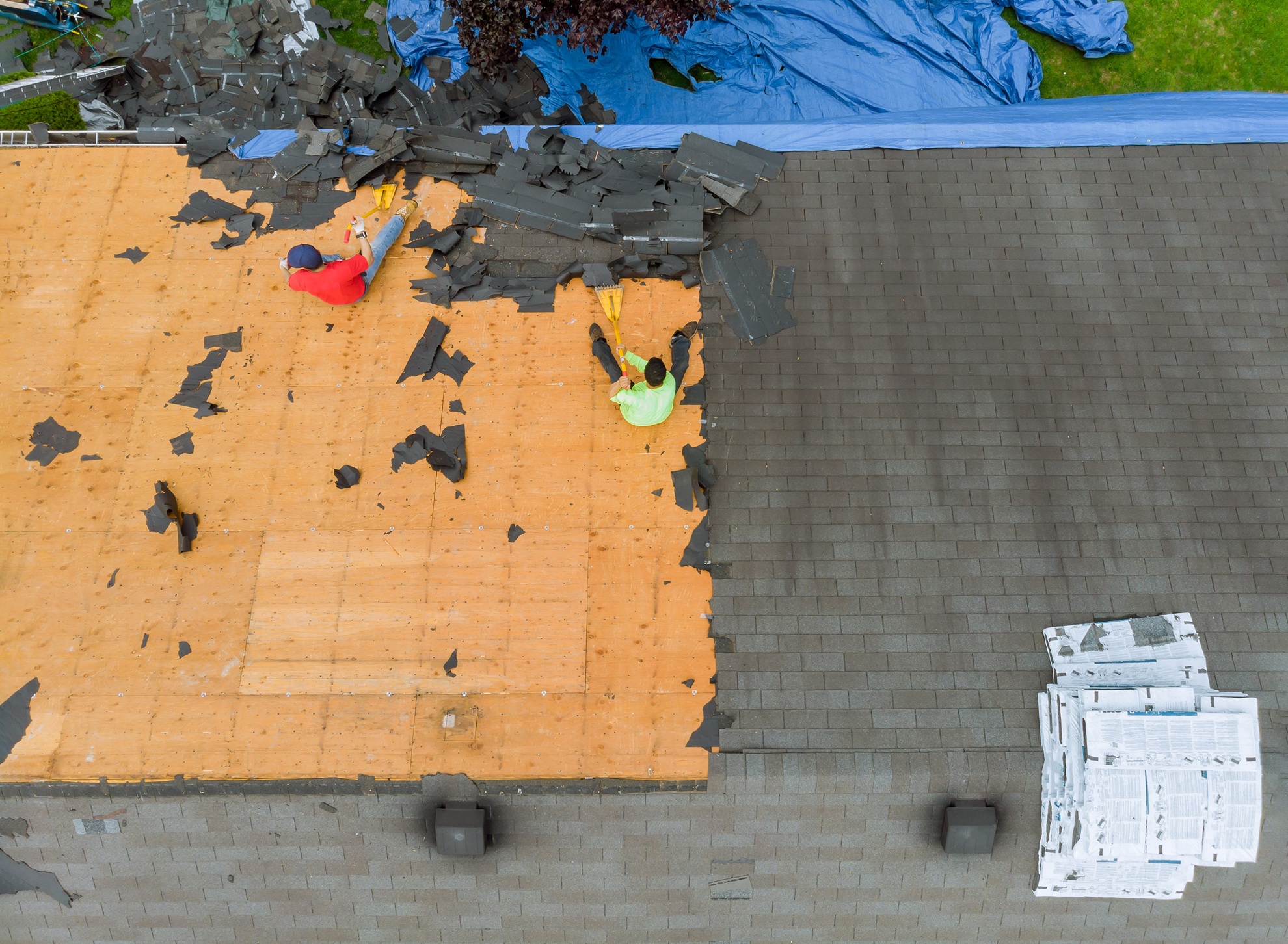 Image of an old roof being removed and replaced by residential roofing experts in Albuquerque