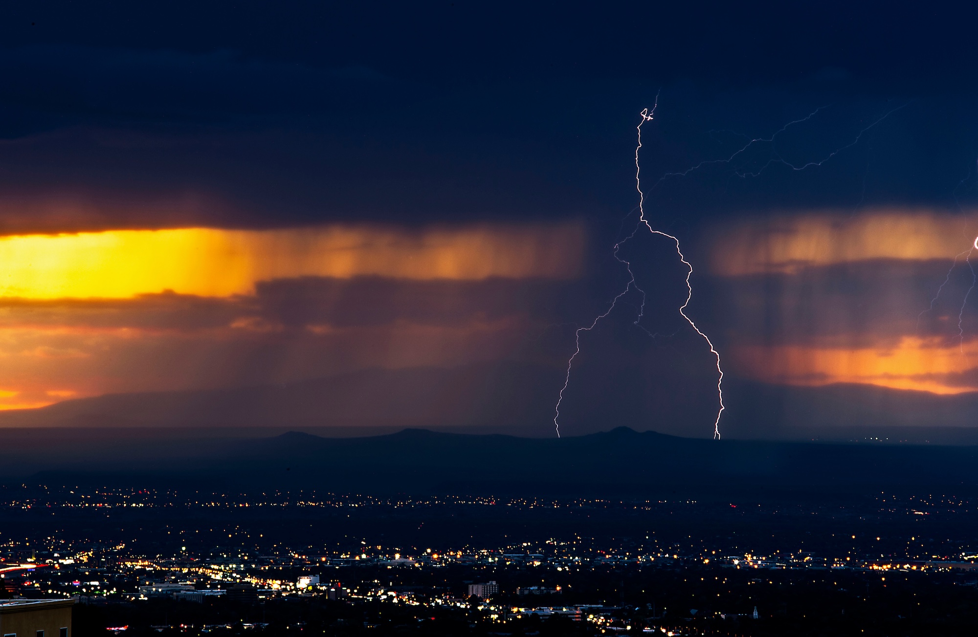 Image of a man holding an electric screw driver admiring expert roofing in Albuquerque
